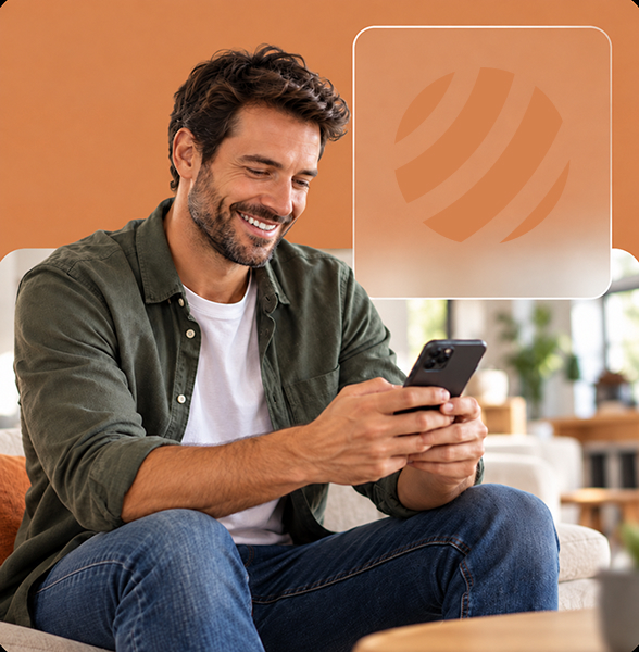 Smiling man using a smartphone in a bright, modern indoor setting.